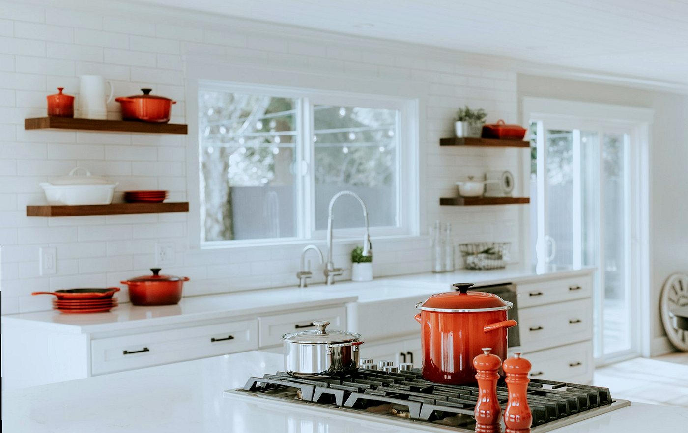 White kitchen with subway-tiled wall and white worktops
